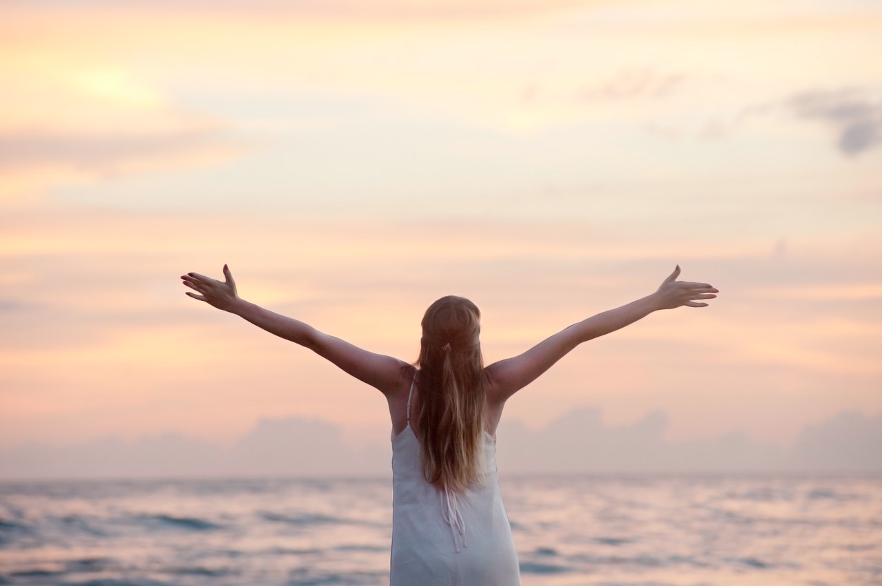 Nutritional Support for the Elderly and Special Diets rear view of woman with arms raised at beach during sunset 320007 - Nutritional Support for the Elderly and Special Diets